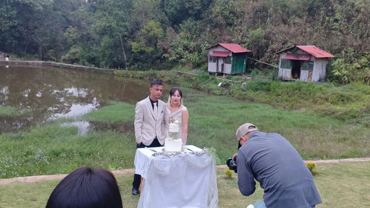 Couple celebrating beside the pond at Nalari Resort Sumer